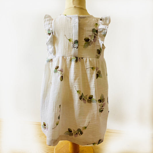 Achterkant van het Jurkje Eucalyptus met knoopsluiting, gemaakt van zachte hydrofiel stof. Verkrijgbaar in maat 74-104 bij Cuteez.