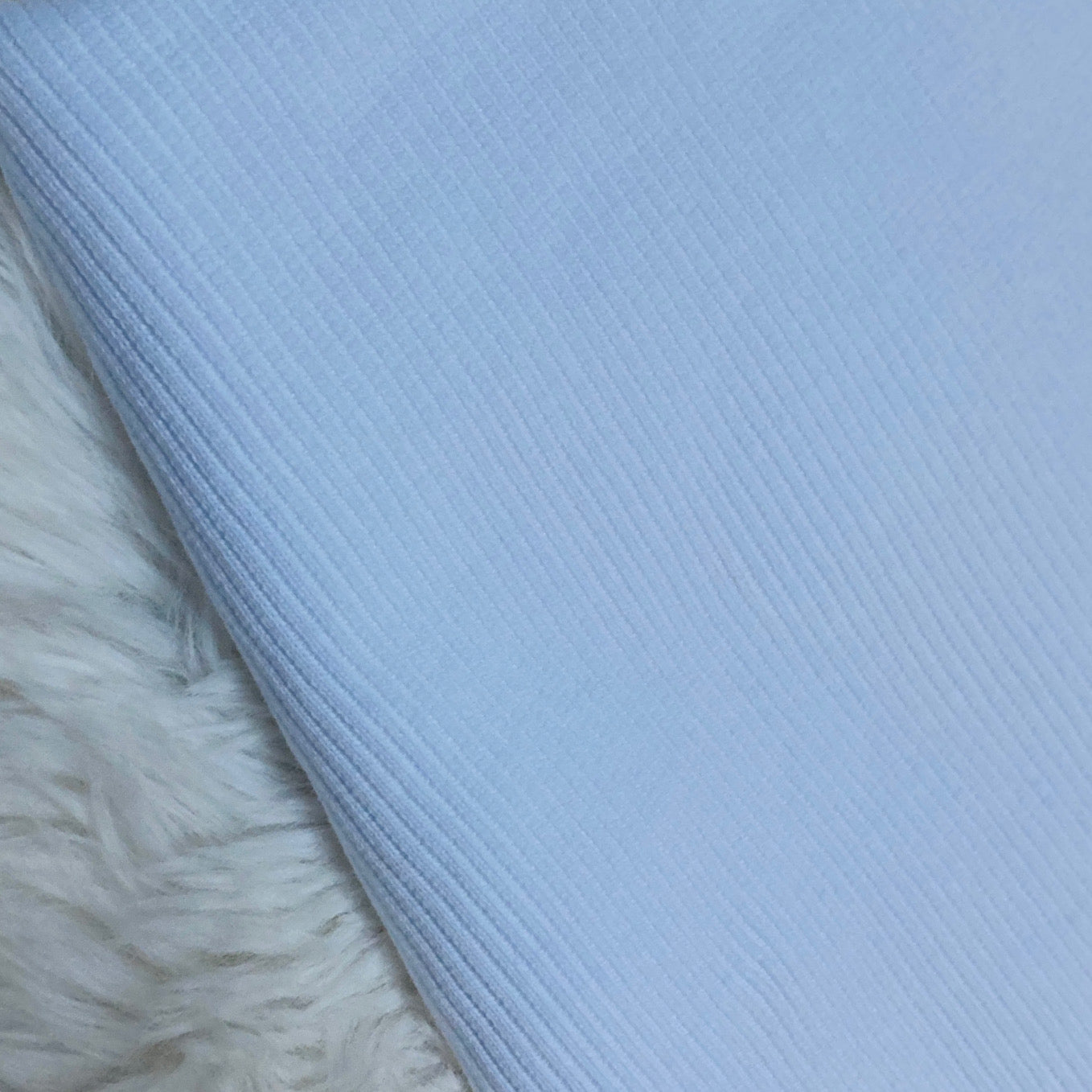 Bright white ribbed fabric for handmade baby and children's clothing.