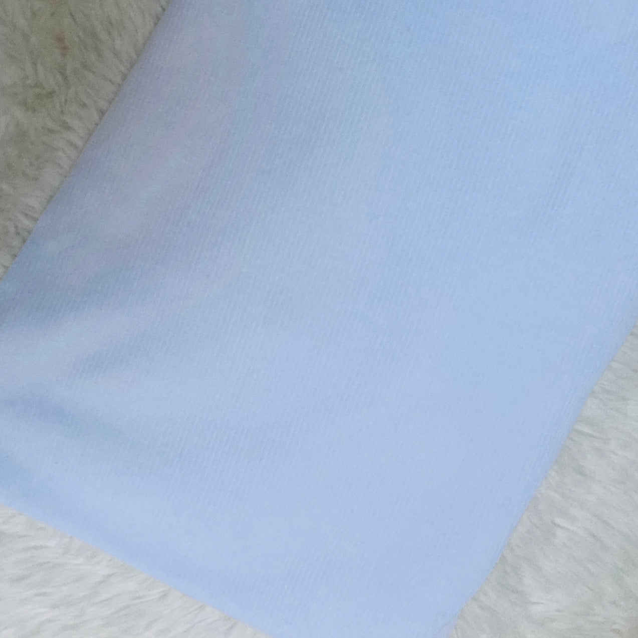 Bright white ribbed fabric for handmade baby and children's clothing.